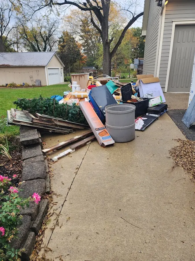 Dumpster being loaded with debris for Residential Dumpster Rental in Rainsville